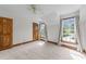 Bedroom featuring carpet, two windows, and neutral color scheme at 6420 Dresden Ln, Raleigh, NC 27612