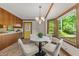 Cozy breakfast nook with a round table, seating for four, and a large bay window overlooking the yard at 6420 Dresden Ln, Raleigh, NC 27612
