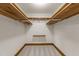 Spacious walk-in closet with built-in wooden shelving for organization at 6420 Dresden Ln, Raleigh, NC 27612