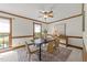 Traditional dining room with wood trim, a ceiling fan, a table with four chairs, and natural light at 6420 Dresden Ln, Raleigh, NC 27612
