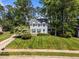 Charming two-story home with light-green siding, dormer windows, dark shutters, and a well-manicured lawn at 6420 Dresden Ln, Raleigh, NC 27612