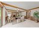 Spacious living room featuring a brick fireplace, exposed beams, wainscoting, and comfortable seating at 6420 Dresden Ln, Raleigh, NC 27612
