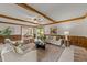 Inviting living room with exposed beams, wainscoting, comfortable seating, and an open floor plan at 6420 Dresden Ln, Raleigh, NC 27612