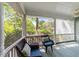 Inviting screened porch with wicker seating and serene views of the surrounding greenery at 6420 Dresden Ln, Raleigh, NC 27612
