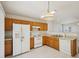 Functional kitchen featuring wood cabinets and white appliances at 649 Flaherty Ave, Wake Forest, NC 27587