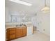 Well-lit kitchen featuring wood cabinets, laminate countertops, and neutral tile floors at 649 Flaherty Ave, Wake Forest, NC 27587