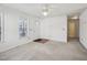Bright, carpeted living room featuring a large window and a front door at 649 Flaherty Ave, Wake Forest, NC 27587