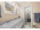 Well-lit bathroom with a white vanity and a view into the walk in closet at 6612 Rossford Ln, Durham, NC 27713