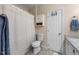 Clean, neutral bathroom features a shower/tub combo, vanity, and built-in cabinet for storage at 6612 Rossford Ln, Durham, NC 27713
