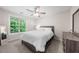 Comfortable bedroom featuring a large window with natural light and wooden furnishings at 6612 Rossford Ln, Durham, NC 27713