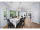 Sunlit dining room featuring a wood table, chairs and an elegant chandelier at 6612 Rossford Ln, Durham, NC 27713