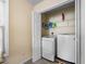 Functional laundry area with modern washer and dryer units, wire shelving at 6612 Rossford Ln, Durham, NC 27713