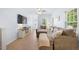 Inviting living room with hardwood floors, a comfortable sectional sofa, and abundant natural light at 6612 Rossford Ln, Durham, NC 27713