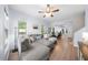 Spacious living room boasts wood floors and a comfortable sectional sofa, with an open view into the dining area at 6612 Rossford Ln, Durham, NC 27713