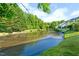 Scenic view of a lush pond surrounded by greenery, offering a tranquil setting near the home at 6612 Rossford Ln, Durham, NC 27713