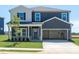 Charming two-story home with attached two-car garage and well-manicured lawn at 676 White Birch Ln, Angier, NC 27501