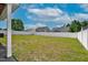 Large backyard with a white fence, grass, and various trees in the background at 6921 Peppermill Way, Rocky Mount, NC 27804