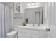 Bathroom with a white vanity, neutral walls, a framed mirror, and classic tile flooring at 6921 Peppermill Way, Rocky Mount, NC 27804