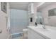 Bathroom with a white sink and vanity with drawers and white and blue shower curtain at 6921 Peppermill Way, Rocky Mount, NC 27804