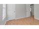 Bedroom with hardwood floors, bright neutral walls, doors and a window at 6921 Peppermill Way, Rocky Mount, NC 27804