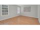 Bedroom with two windows, neutral walls, hardwood floors, and bright natural lighting at 6921 Peppermill Way, Rocky Mount, NC 27804