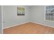 Empty bedroom with neutral walls, wood look floors and bright natural lighting at 6921 Peppermill Way, Rocky Mount, NC 27804