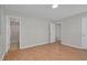 A well-lit bedroom with hardwood floors, two closets, and a view of the bathroom at 6921 Peppermill Way, Rocky Mount, NC 27804