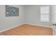 Bedroom with wood-look floors, light gray walls, a window, and bright natural lighting at 6921 Peppermill Way, Rocky Mount, NC 27804
