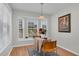 Breakfast nook with bright windows, wood-look flooring, seating for two, and an overhead light fixture at 6921 Peppermill Way, Rocky Mount, NC 27804