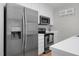 Kitchen featuring stainless steel appliances, white countertops, and light wood flooring at 6921 Peppermill Way, Rocky Mount, NC 27804
