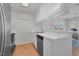 Bright kitchen features white cabinets, appliances, and a pass-through window to the dining area at 6921 Peppermill Way, Rocky Mount, NC 27804