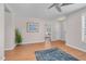 Living room featuring a ceiling fan, wood-look flooring, neutral paint, and doorways to other rooms at 6921 Peppermill Way, Rocky Mount, NC 27804