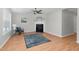 Bright living room featuring a fireplace, ceiling fan, wood-look flooring, and neutral paint at 6921 Peppermill Way, Rocky Mount, NC 27804