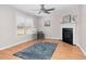 Bright living room featuring a fireplace, ceiling fan, wood-look flooring, and neutral paint at 6921 Peppermill Way, Rocky Mount, NC 27804