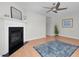 Living room featuring a fireplace, ceiling fan, wood-look flooring, and neutral paint at 6921 Peppermill Way, Rocky Mount, NC 27804