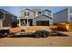 New two-story home featuring gray siding, an open garage, a front porch with space for seating, and unfinished landscaping at 712 Deschutes Dr, Garner, NC 27529