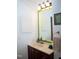 Well-lit bathroom with custom mirror, towel bar, vanity, and cabinet at 7177 Sandy Creek Dr, Raleigh, NC 27615