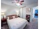 Bright bedroom with ceiling fan, queen bed, side tables, and wardrobe at 7177 Sandy Creek Dr, Raleigh, NC 27615