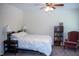 Cozy bedroom with a queen bed, lamps, and a bookcase at 7177 Sandy Creek Dr, Raleigh, NC 27615