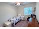 Bright bedroom with a comfortable bed, a chair, and an expansive window at 7177 Sandy Creek Dr, Raleigh, NC 27615