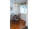 Charming dining area featuring a round table, chandelier, and natural light from the window at 7177 Sandy Creek Dr, Raleigh, NC 27615