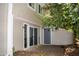 Rear exterior with sliding glass doors, blue door, and patio at 7177 Sandy Creek Dr, Raleigh, NC 27615