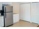 Spacious kitchen area with white cabinets, stainless steel refrigerator, and ample storage space at 7177 Sandy Creek Dr, Raleigh, NC 27615