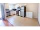 Bright kitchen with white cabinets, stainless steel appliances, and tile flooring for easy maintenance at 7177 Sandy Creek Dr, Raleigh, NC 27615