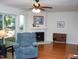Comfortable living room with a fireplace, a blue recliner, and sliding glass doors at 7177 Sandy Creek Dr, Raleigh, NC 27615