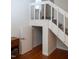 Staircase with a small door and carpeted steps at 7177 Sandy Creek Dr, Raleigh, NC 27615