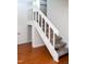 Staircase with carpeted steps and white railings at 7177 Sandy Creek Dr, Raleigh, NC 27615
