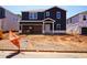 Two-story home featuring navy siding, a white trim, and an attached garage during the final phase of construction at 749 Deschutes Dr, Garner, NC 27529