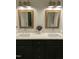 Bathroom with double sinks, modern fixtures, framed mirrors, and dark green cabinets at 7501 Tipsy Sq, Wake Forest, NC 27587