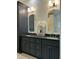 Modern bathroom with double sinks, granite countertop vanity, and stone tile floors at 7501 Tipsy Sq, Wake Forest, NC 27587